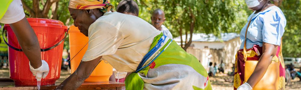 Two women washing their hands in Muona, Nsanje District (Southern Malawi).