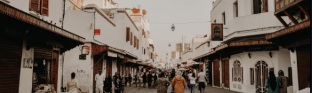People walking down a street in Morocco.