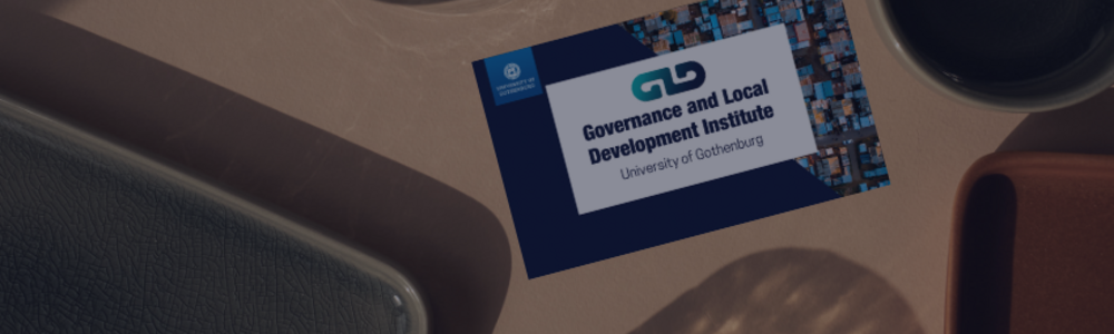 A GLD business card laying on an office desk.